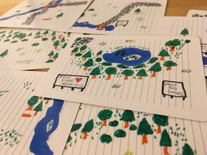 An assortment of cards with a hand drawn map on the.