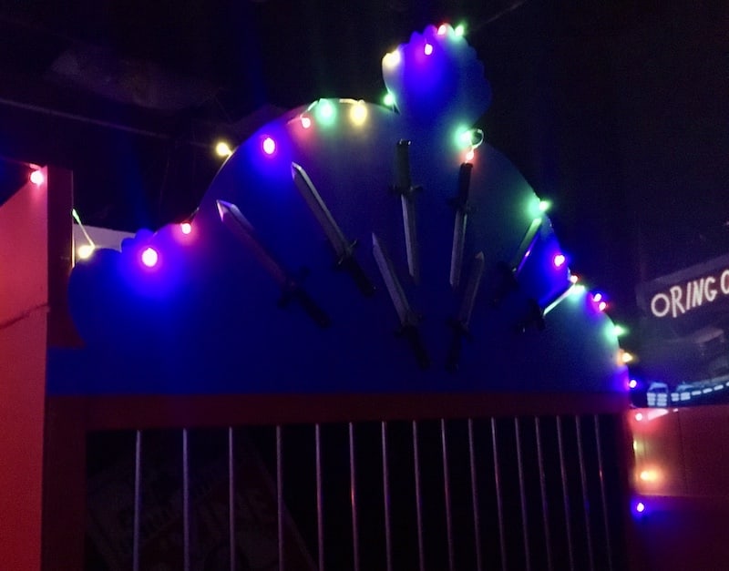 In-game: A cage decorated with knives and lit with a string of lights.