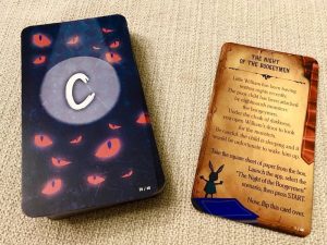 A stack of player cards on the left, the card backs are covered with glowing red eyes beside a story card explaining that a child is being hauned by monsters at night.