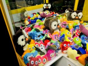 In-game: the inside of a claw machine, filled with stuffed animals.