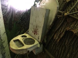 In-game: a wooden backpack with slots for the objective items.