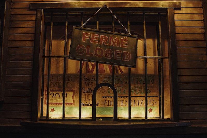 In-game: The ticketbooth for the circus with a closed sign hanging from it.