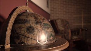In-game: closeup of a globe in a study.