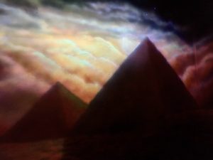 In-game: a beautiful mural of Egyptian pyramids in the moonlight.