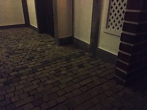 In-game: The cobblestone street of Pudding Lane.