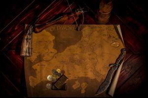 In-game: a map of a fantasy land surrounded by gold, and weapons.