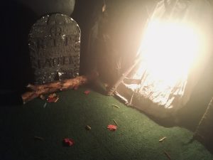 In-game: A grave site at night.