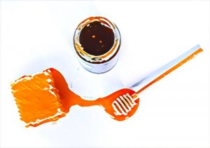 Honey next to a honecomb.