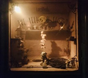 In-lobby: a storefront labeled, "The Yellow Sign."