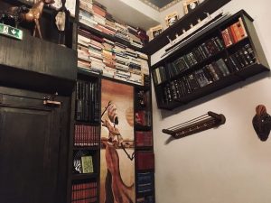 In-game: Walls filled with books and African art.