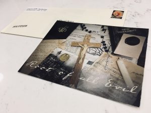 A postcard with a crucifix that reads "Root of All Evil."