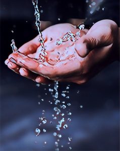 Hands being washed in water.