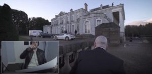 Hitman approaching a mansion.