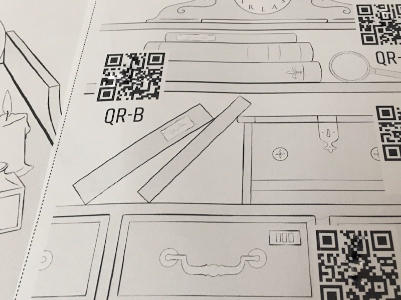 A black & white printed page depicting a bookcase labeled with QR codes.
