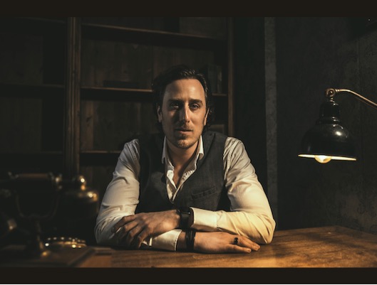 Gijs Geers sitting behind a desk