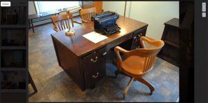 An old desk with a typewriter.