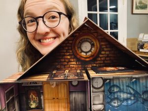 Lisa peering over the dollhouse.