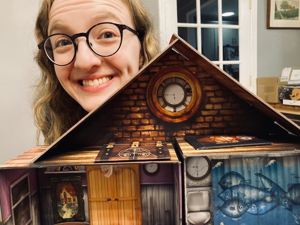 Lisa peering over the dollhouse.