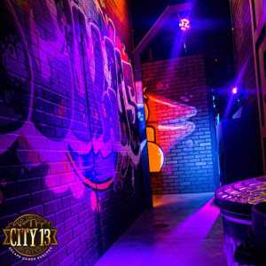 A city street set with graphitti on the walls.