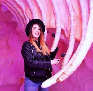 Cara Mandel inside some giant pink animal