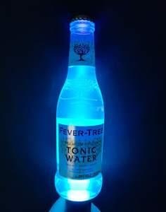A fever tree bottle glowing under blacklight.