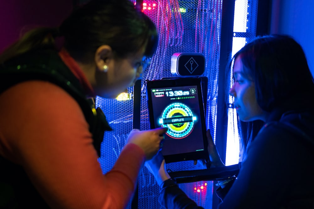 Two players interacting with a tablet.