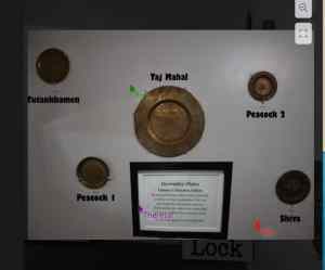 5 labeled plates on a wall in a museum.
