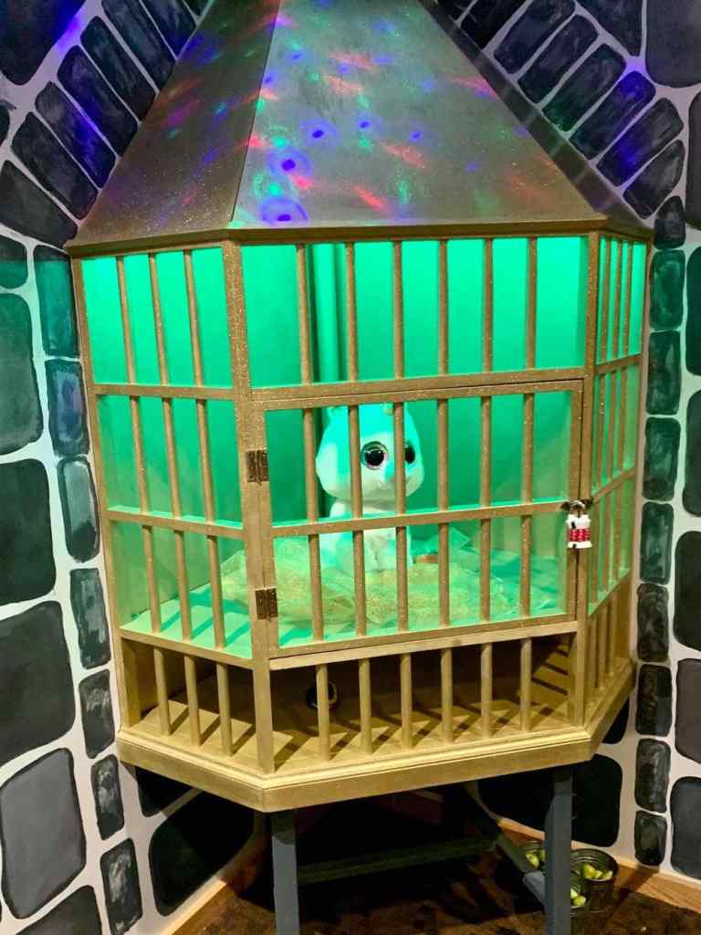 A baby unicorn in a cage.