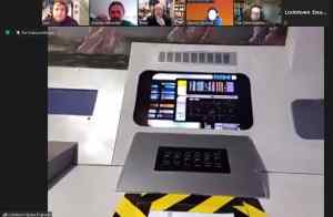 Console on a space station viewed through Zoom.