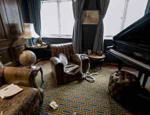 A crime scene with a ransacked office, a rope, and a silver platter.