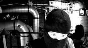 View of a masked person through a webcam.