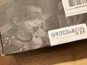 The Gruzzle box depicts a child looking through a magnifying glass.