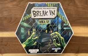 Break In Area 51 box art shows alien hands opening a chainlink fence.