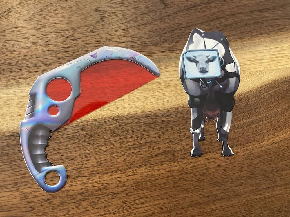 A strange laser sword with a transparent red filter. A cow with a television screen for a head.