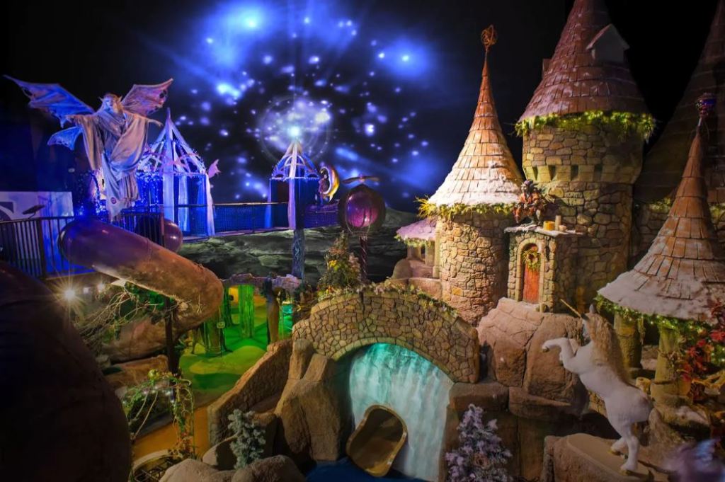 Indoor playground with fantasy themes including a castle, unicorn and slides.