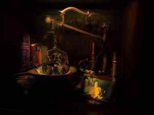 antique scale with a pair of steampunk binoculars, books and a photo frame