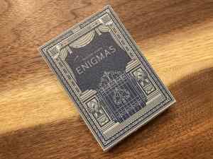 The elegant blue and grey box art for David Kwong's Enigmas deck.