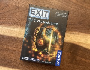 Exit The Game - The Enchanted Forest box art depicts a living tree reaching out for a frog prince.