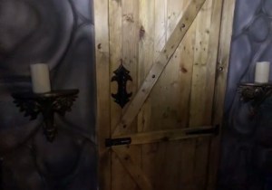 A wooden door within a stone castle.