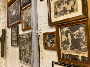 An assortment of framed black & white images of boxing matches.