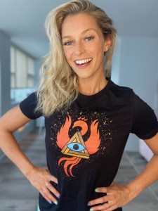 Woman wearing a black t-shirt with the RECON 21 phoenix and a hidden message.