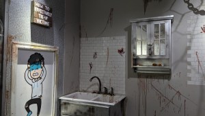 A bloodied sink beside a sign that reads, "How to effectively tie-up victims"