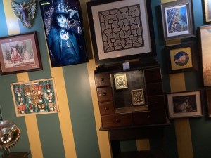 Assorted images hung on the wall of an old New Orleans curio shop.