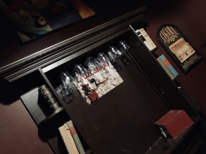 Back bar area with glasses, books, and a red locked box.