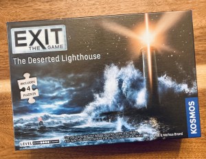 Exit Deserted Lighthouse box art depicts an illuminated lighthouse in the middle of rough seas at night.
