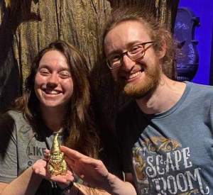 Matthew & Theresa holding their golden gnome.