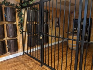 Gated and padlocked divider in a wine cellar.