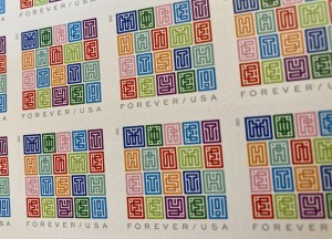 Closeup of the US Mystery Message puzzle stamp. Careful inspection reveals the phrase, "More than meets the eye!"