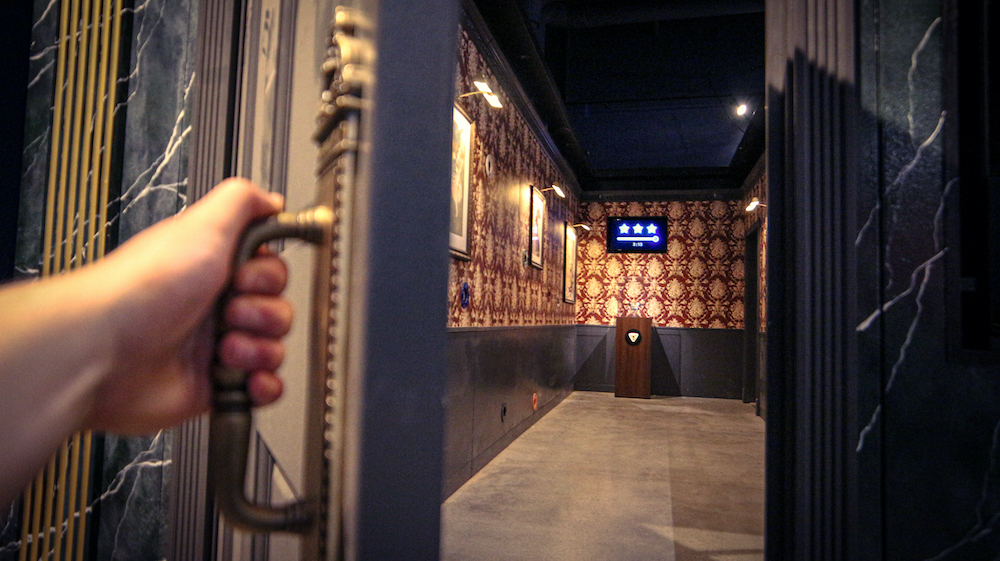 A player opening the door the Museum Heist game.