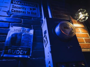 Closeup of an electrical meter, beside it is a missing dog poster.
